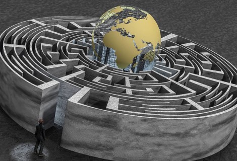 Man in front of labyrinth with globe