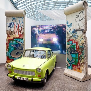 Original Berlin Wall with Trabi and film of the opening of the Berlin Wall in 1989