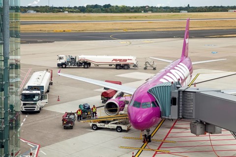 Airplane at the passenger boarding bridge on the runway
