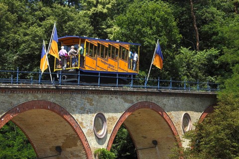 Waggon of Nerobergbahn drives over arch bridge