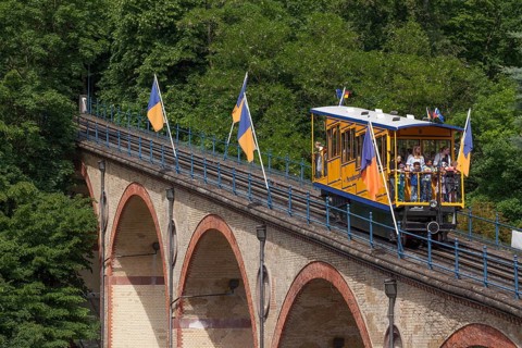 Waggon of Nerobergbahn drives over arch bridge