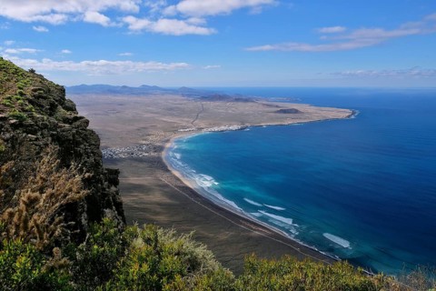 View from Mirador del Bosquecillo to Caleta de Famara with beach Playa de Famara