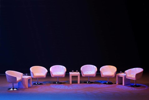 Podium with empty armchairs on a stage