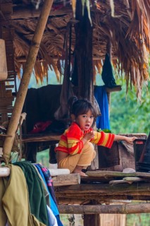 Young girl sitting in a hut