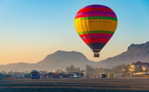 Colorful hot air balloon in the air before landing