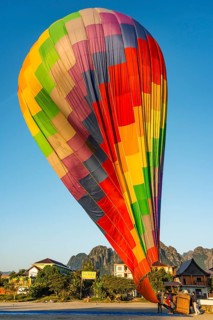 Colourful hot air balloon on ground after landing