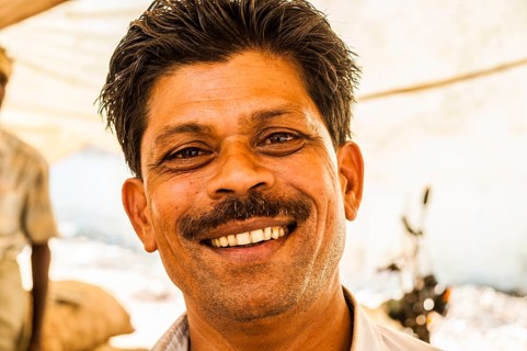 Laughing shopkeeper in a market