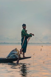 Local fishermea leg rower with wooden boat