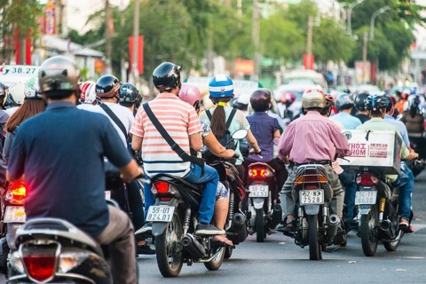 Crowd of scooter drivers in heavy traffic
