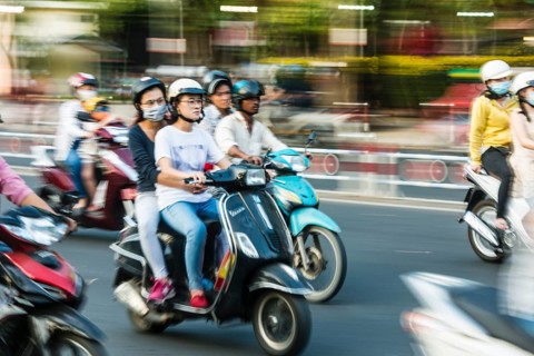 Scooter drivers in heavy traffic