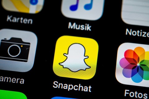 Smartphone screen display with Photos and Snapchat app icons in detail
