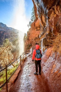 Hiker in front of waterfall