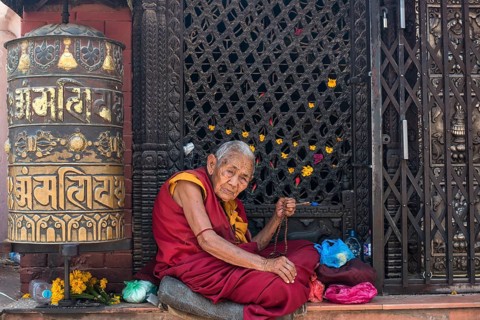 Old woman with prayer beads