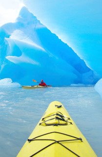 Kayaker heading for icebergs on Lago Grey