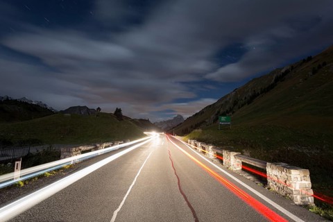 Pass road at night with light streaks from cars on Hochtannbergpass