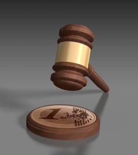 Gavel in front of grey background