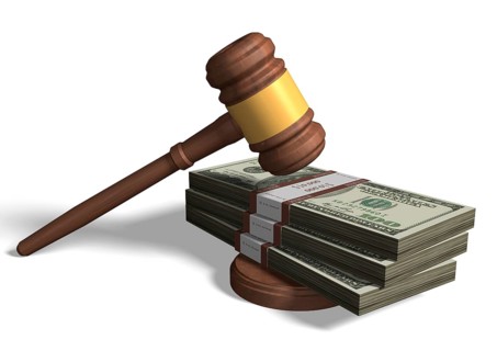 Gavel on bundle of dollar bills