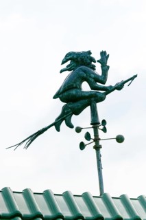 House roof with weather vane with weather witch