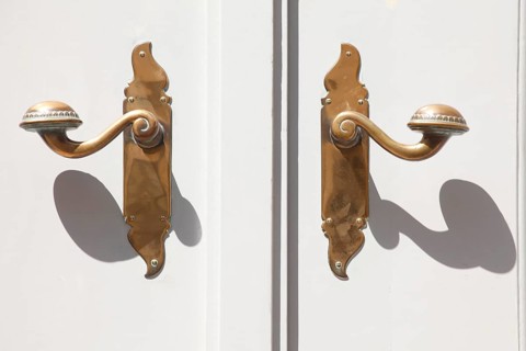 Old door handles on white door