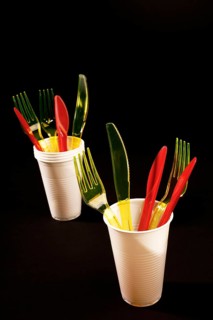 Red and yellow plastic cutlery in white plastic cups