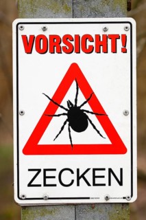 Warning sign Caution ticks