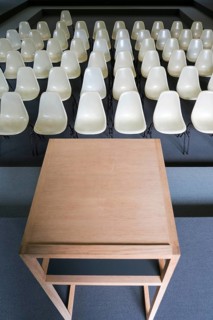 Empty chairs with desk in an auditorium