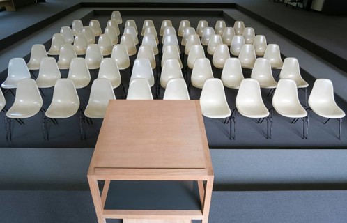 Empty chairs with desk in an auditorium