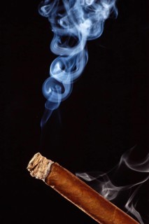Burning cigar with cigar smoke