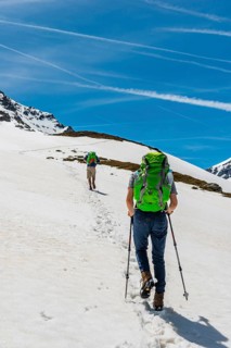Two hikers walk over snowfield