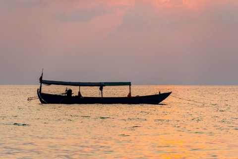 Boat on sea at sunrise from Koh Tui Beach