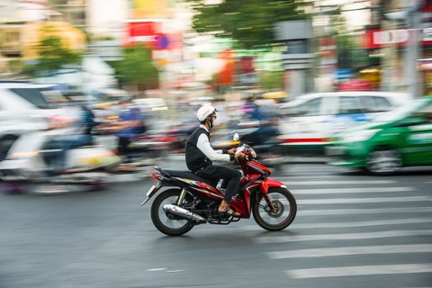 Scooter driver in heavy traffic