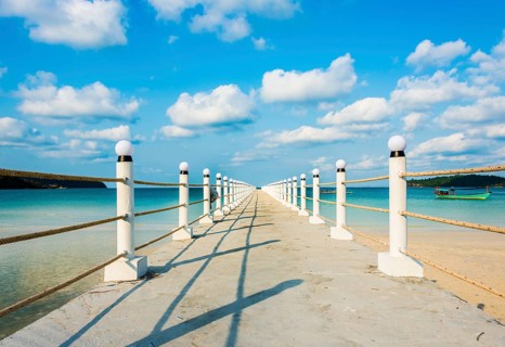 Pier on beach with turquoise water at Saracen Bay on Koh Rong Sanloem island