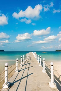 Pier on beach with turquoise water at Saracen Bay on Koh Rong Sanloem island