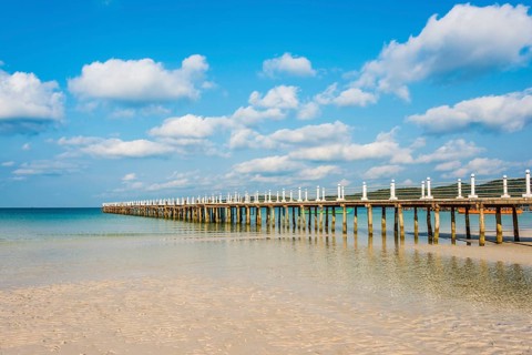 Pier on beach with turquoise water at Saracen Bay on Koh Rong Sanloem island