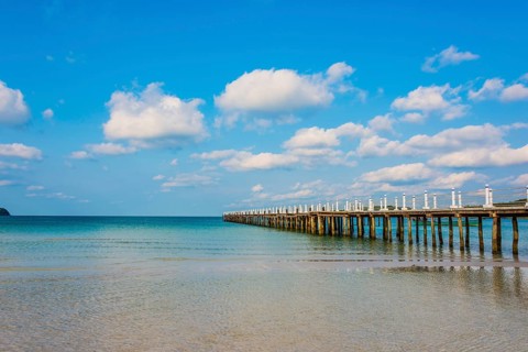 Pier on beach with turquoise water at Saracen Bay on Koh Rong Sanloem island