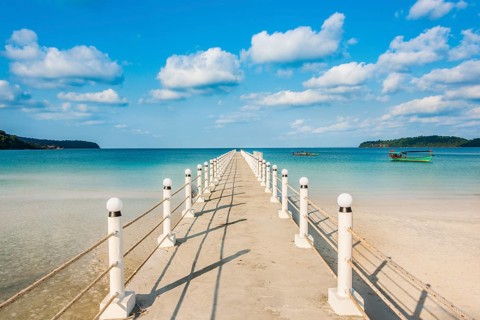 Pier on beach with turquoise water at Saracen Bay on Koh Rong Sanloem island