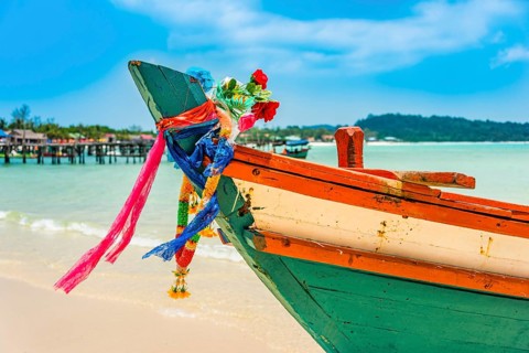 Idyllic sandy beach with traditional long-tail boat at Long Beach