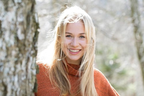 Portrait of a laughing young woman with long blond hair