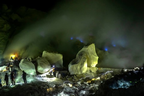 Workers in toxic sulfur mining in sulfur mine at night
