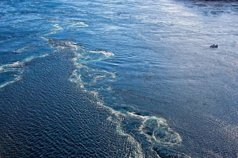 Small fishing boat near a dangerous whirlpool