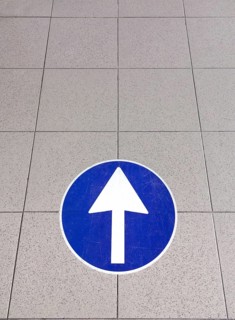 White directional arrow sign