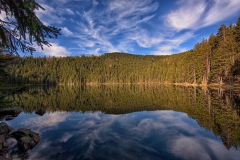 Reflection with clouds in Certovo jezero lake in fall