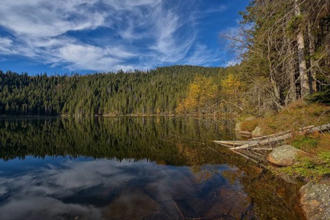 Reflection with clouds in Certovo jezero lake in fall