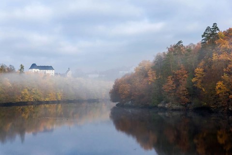 Burgk Castle in morning fog on the Saale river