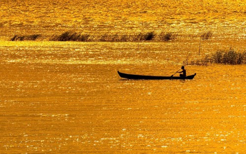 Man paddling boat on River Ayeyarwady or Irrawaddy
