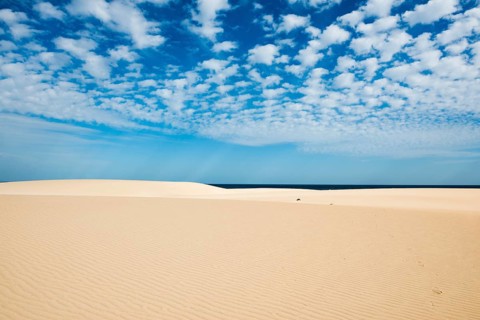 Dunes against blue sea