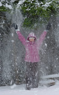 Girl enjoying the snow in winter
