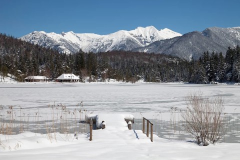 Frozen lake Lautersee in front of Karwendel Mountains
