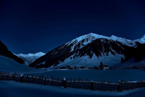 Farming village at night with starry sky in winter