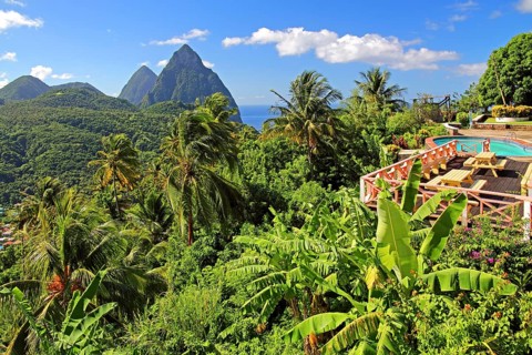 Terrace with swimming pool of the La Haut Resort in front of the tropical landscape with the two Pitons